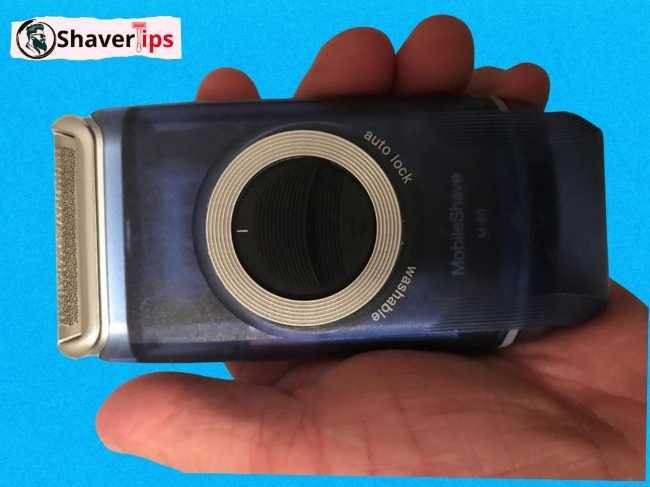 Braun Pocket Shaver on hand with battery in
