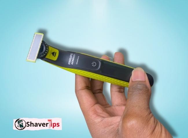 Philips Norelco razor in hand, close view